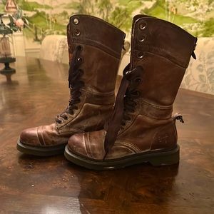 Tall Doc Martens with ribbon laces.